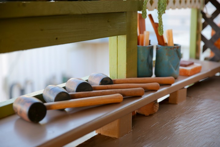 hammers placed on top of a wooden table